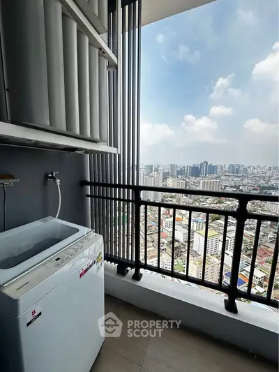 High-rise balcony with washing machine and stunning cityscape view