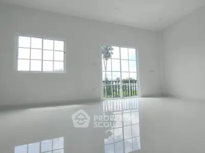 Spacious minimalist room with large windows and glossy floor, offering serene garden views.