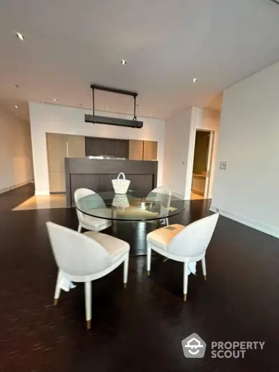 Modern dining area with sleek furniture and elegant lighting in a contemporary apartment.