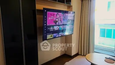 Modern living room with wall-mounted TV and large window view