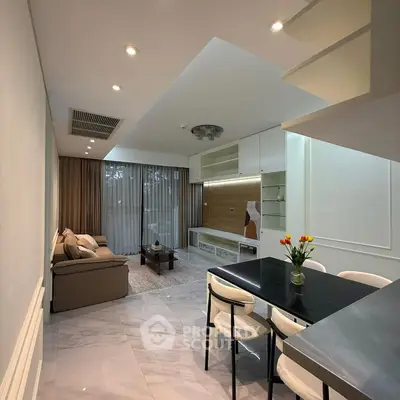 Modern open-plan living and dining area with stylish decor and ample natural light.