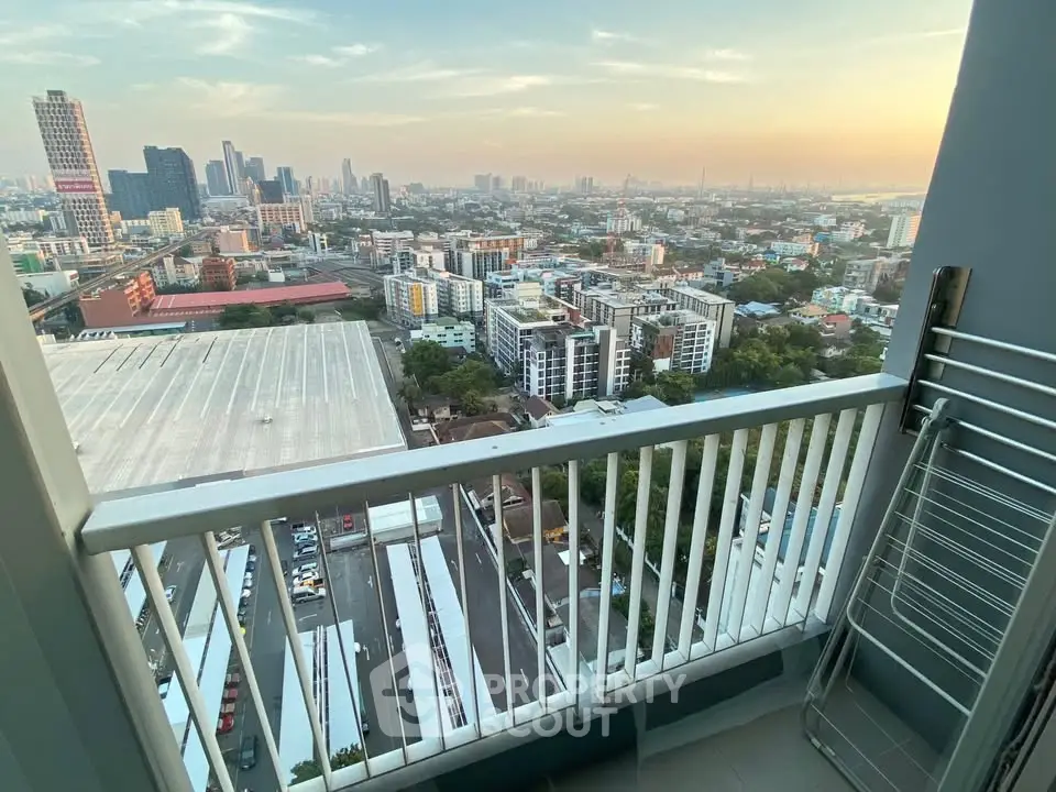 Stunning cityscape view from a high-rise balcony at sunset, perfect for urban living enthusiasts.