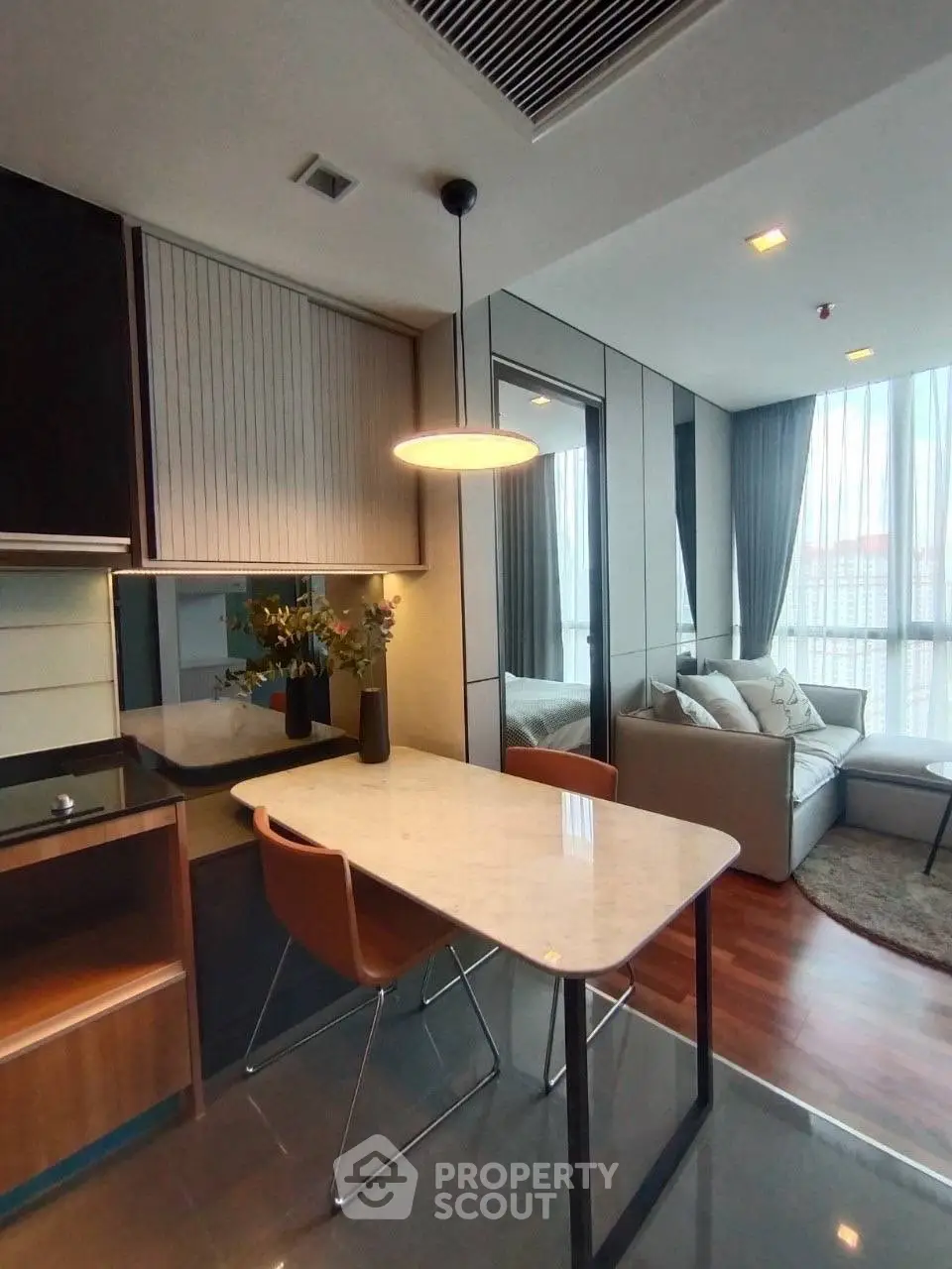 Modern open-plan living and dining area with sleek design and natural light