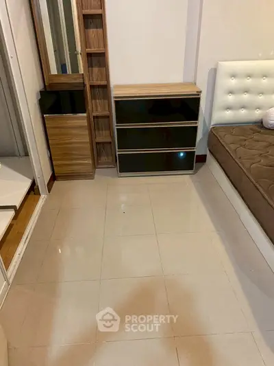 Cozy bedroom with modern furniture and tiled flooring