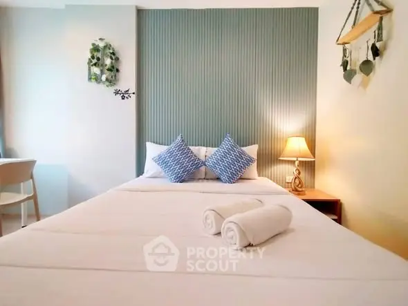 Cozy bedroom with stylish decor and soft lighting, perfect for relaxation.