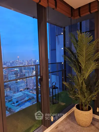 Stunning city view from modern balcony with lush potted plant, perfect for urban living.