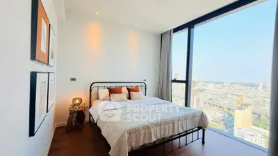 Stunning bedroom with floor-to-ceiling windows offering breathtaking city views, modern decor, and cozy ambiance.