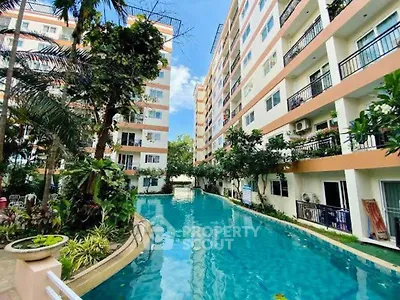 Stunning residential complex with a serene swimming pool and lush greenery.