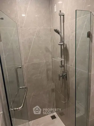 Modern bathroom shower with sleek glass enclosure and contemporary fixtures.