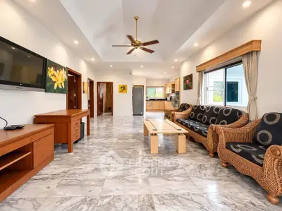 Spacious living room with elegant marble flooring and stylish furniture