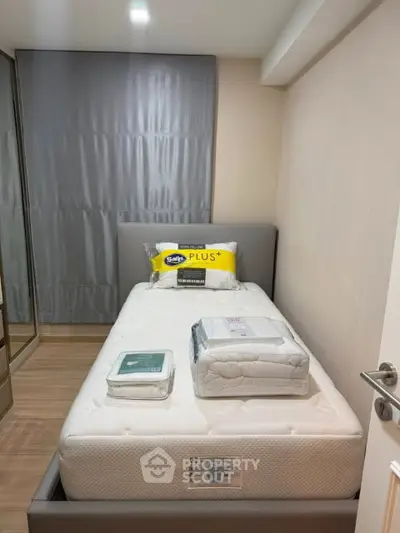Cozy bedroom with single bed and modern decor, perfect for restful nights.