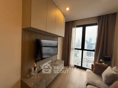 Modern living room with city view, featuring sleek TV setup and cozy seating area.