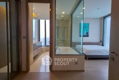 Modern apartment with glass-walled bathroom and spacious bedroom