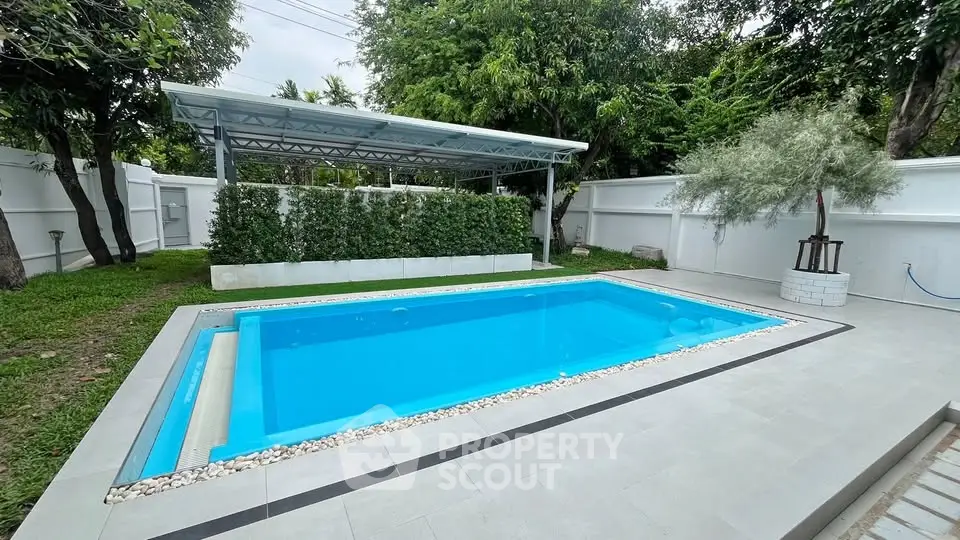 Luxurious private outdoor pool with modern design and lush greenery, perfect for relaxation and entertainment.