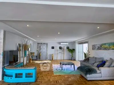 Spacious and stylish living room with modern decor and parquet flooring