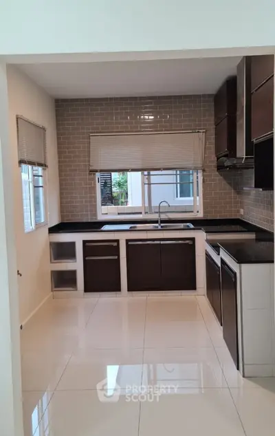 Modern kitchen with sleek cabinetry and tiled backsplash