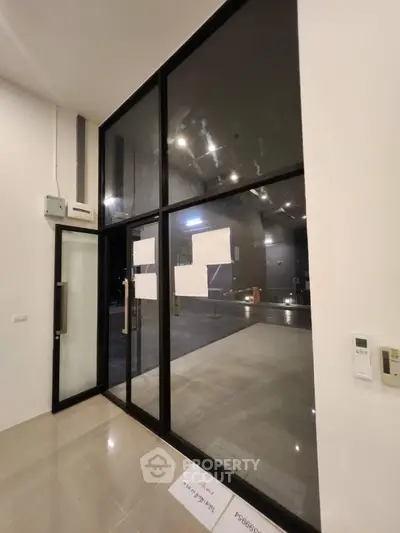 Modern glass entrance with sleek design and spacious interior