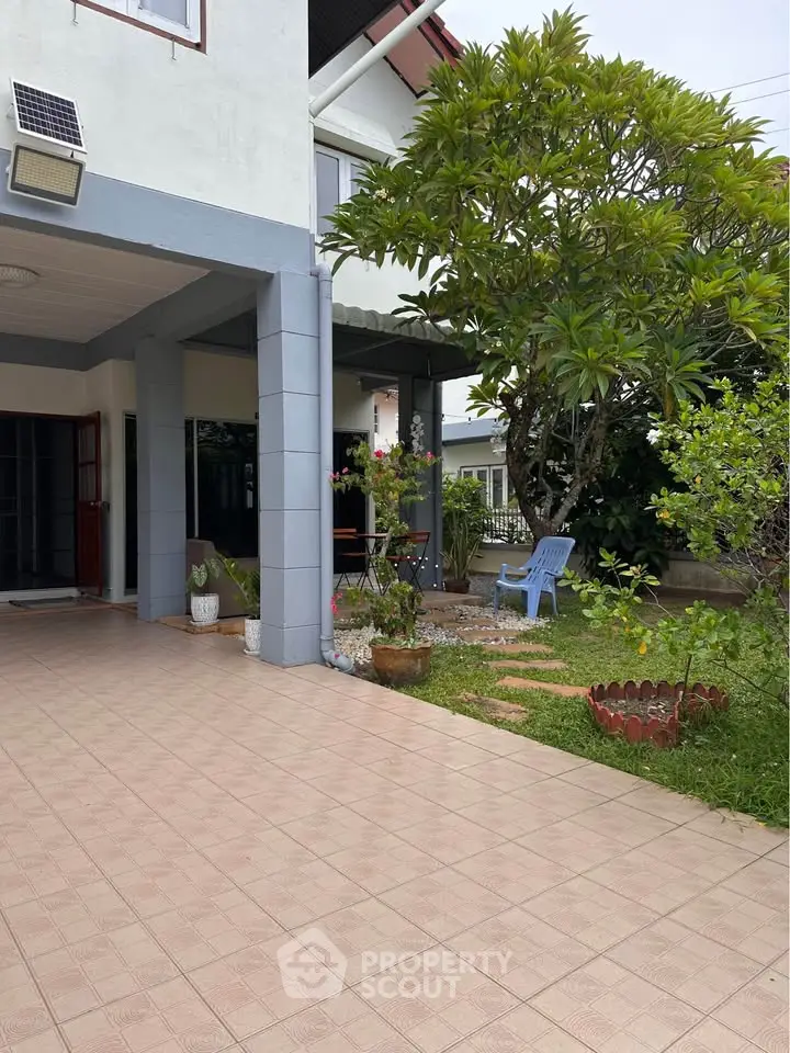 Charming suburban home with spacious patio and lush garden, perfect for outdoor relaxation and entertaining.