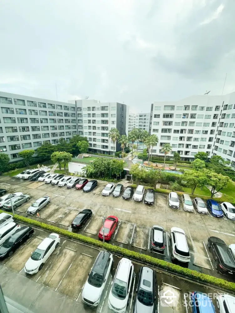 Modern apartment complex with spacious parking and lush greenery