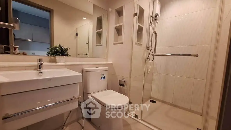 Modern bathroom with glass shower and sleek fixtures in a contemporary home.
