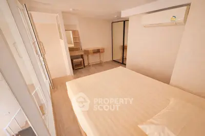 Spacious bedroom with modern furnishings and air conditioning