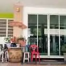 Charming outdoor patio with sliding glass doors and colorful seating area.