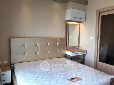 Modern bedroom with stylish headboard and built-in vanity in a contemporary apartment.
