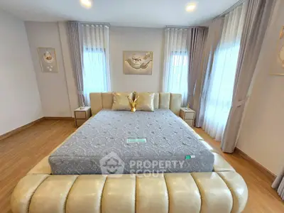 Luxurious bedroom with elegant decor and ample natural light