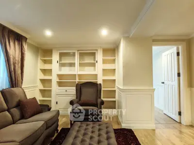 Elegant living room with built-in shelves and cozy seating area