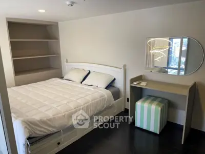 Cozy bedroom with modern decor and built-in shelves, perfect for urban living.