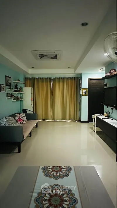 Spacious living room with modern decor and cozy seating area, perfect for relaxation and entertainment.
