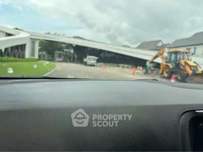 Modern building entrance with construction work in progress, showcasing contemporary architecture.
