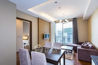 Modern living room with dining area and balcony access in a stylish apartment.