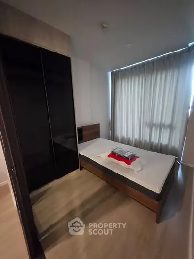 Modern bedroom with sleek wardrobe and cozy bed in stylish apartment
