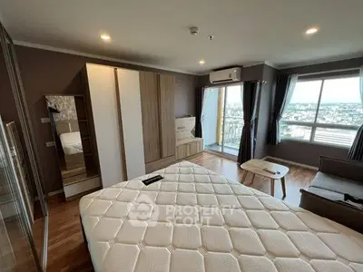 Spacious bedroom with panoramic city view and modern furnishings