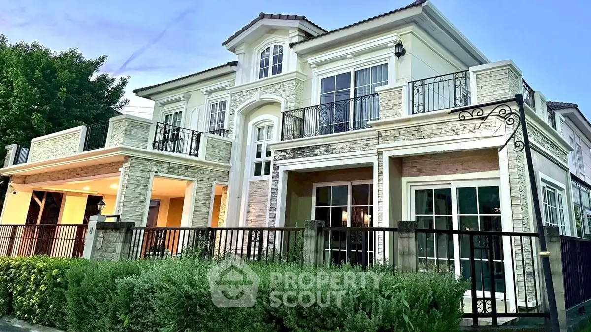 Luxurious two-story house with elegant facade and spacious balcony, perfect for upscale living.