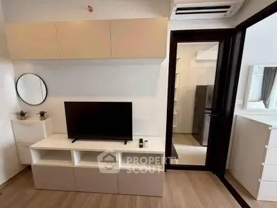 Modern living room with sleek TV stand and wall-mounted cabinets, featuring a minimalist design and wooden flooring.