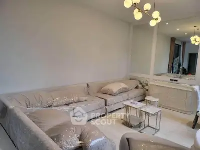 Spacious modern living room with elegant lighting and plush seating, perfect for relaxation and entertainment.
