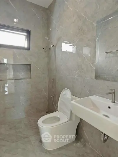 Modern bathroom with sleek marble tiles and contemporary fixtures