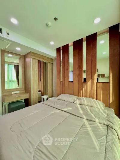 Modern bedroom with stylish wooden accents and cozy bedding in a well-lit space.