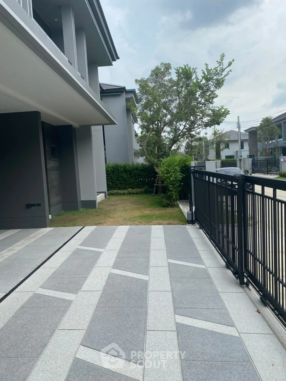 Modern residential driveway with sleek design and lush greenery