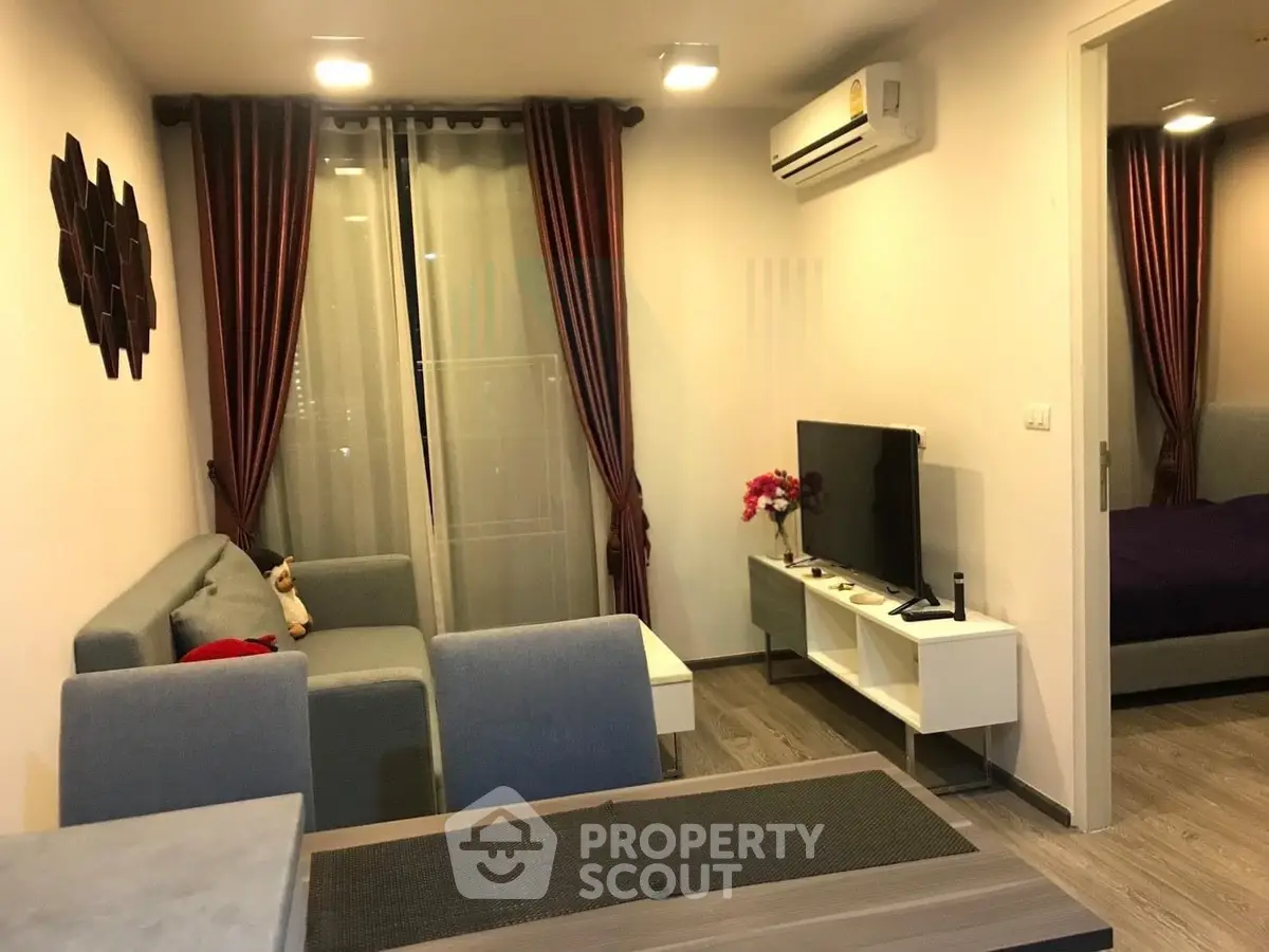 Modern living room with cozy seating and stylish decor in a contemporary apartment.