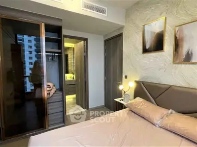 Modern bedroom with stylish decor and ensuite bathroom in a luxury apartment.