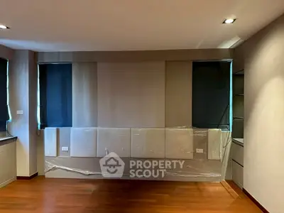 Spacious modern living room with hardwood floors and elegant wall paneling