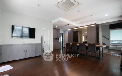 Spacious modern living room with wooden flooring and stylish dining area