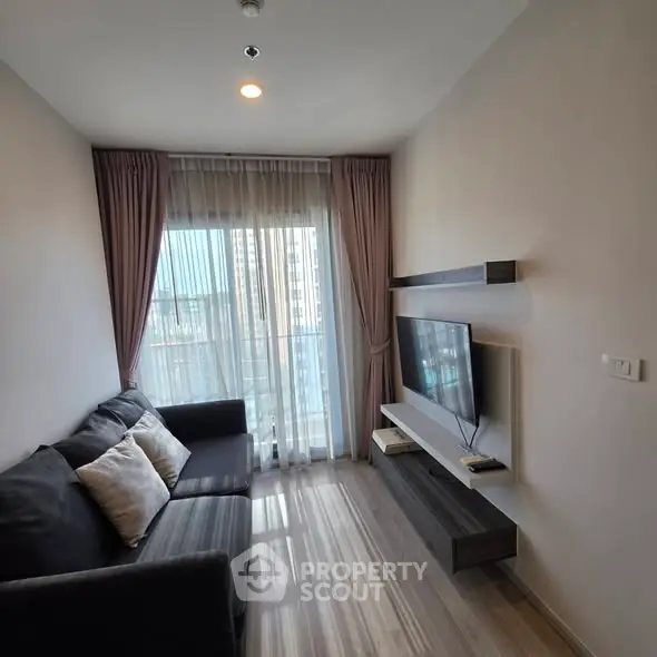 Modern living room with sleek design, featuring a cozy sofa and wall-mounted TV, perfect for urban living.