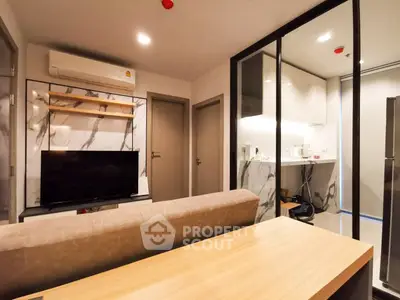 Modern living room with sleek kitchen, featuring marble accents and contemporary furniture.