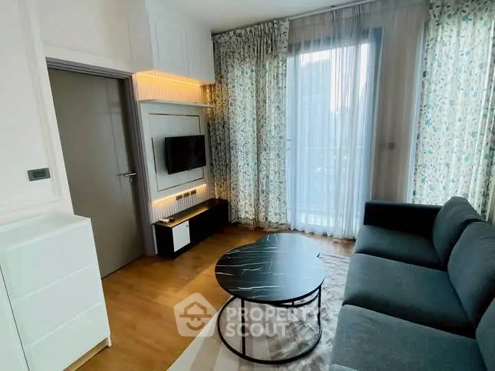 Modern living room with stylish furniture and large window for natural light