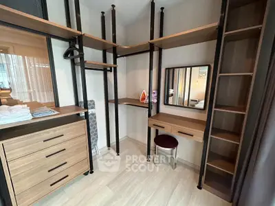 Spacious walk-in closet with modern shelving and vanity area in stylish apartment.