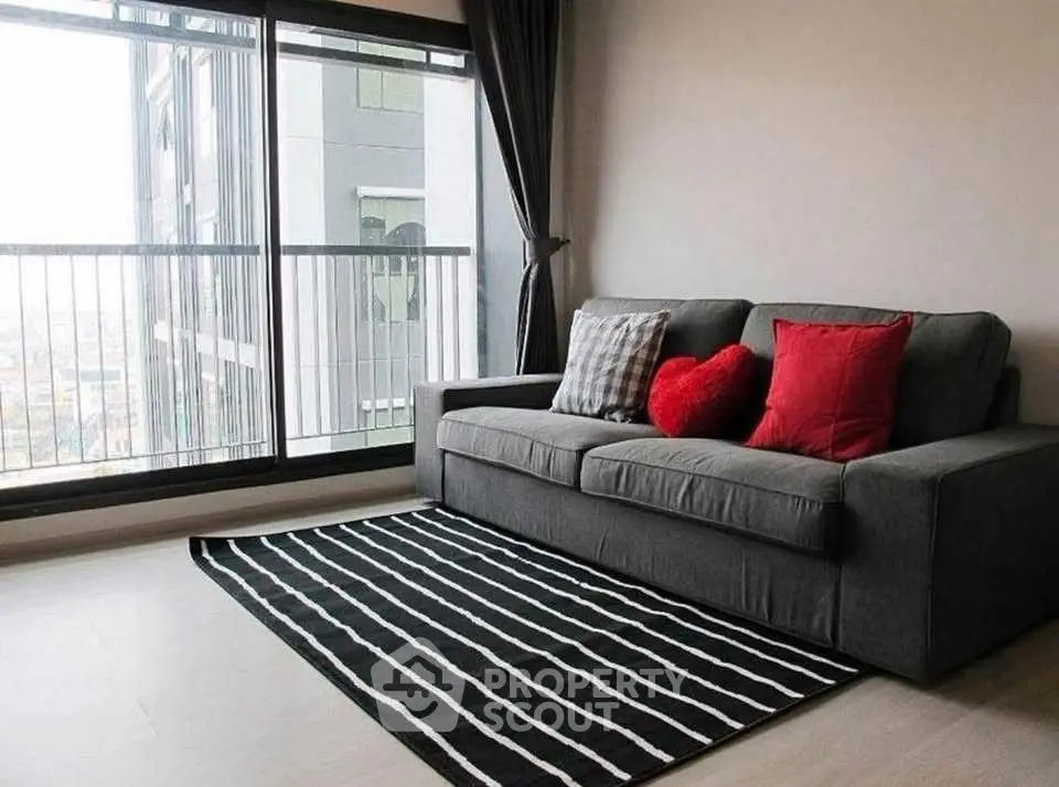 Stylish living room with modern sofa and city view, perfect for urban living.